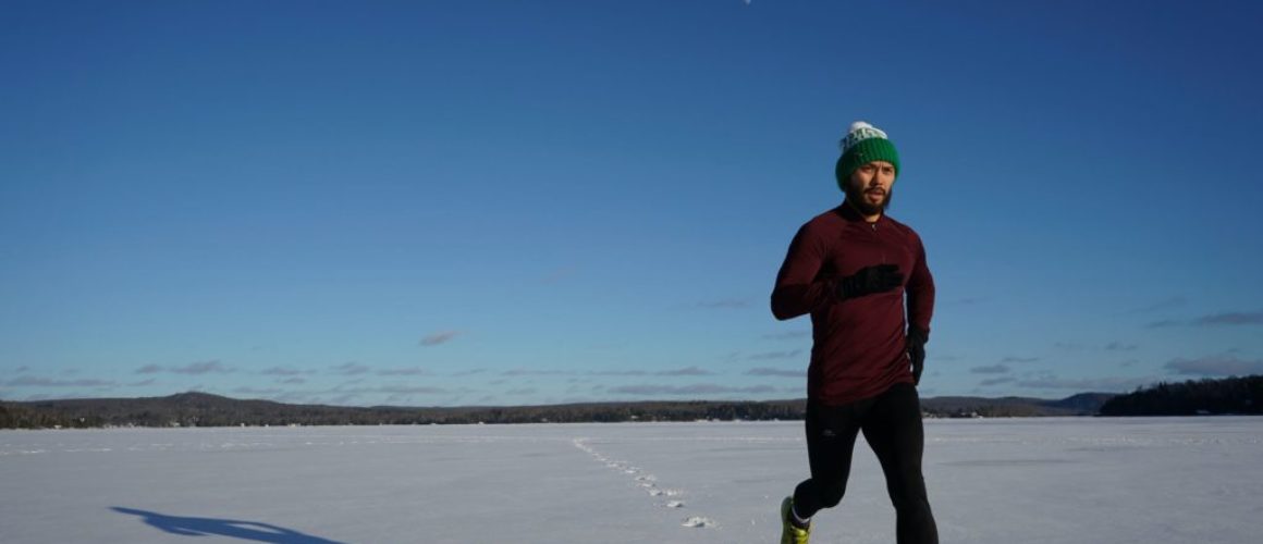 man running in winter landscape
